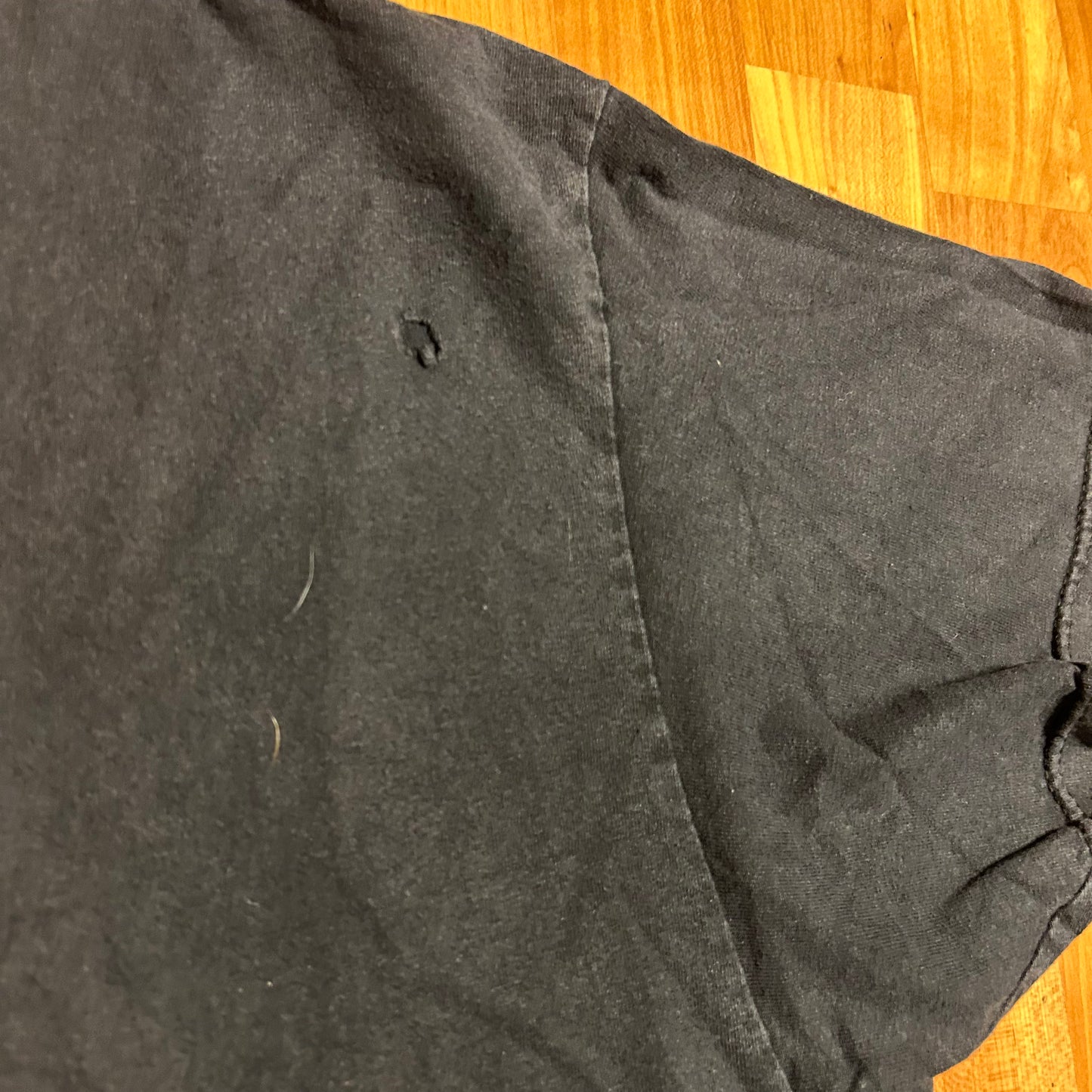 I don’t know what this says can someone help me Black Tshirt - XLarge - 25” x 30”